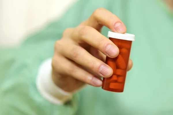 Doctor holding bottle of prescription pi