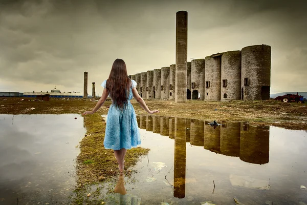 Woman walking among ruins