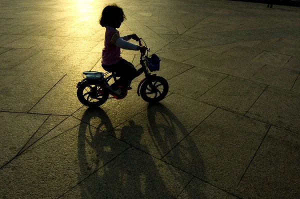 kid riding bicycle