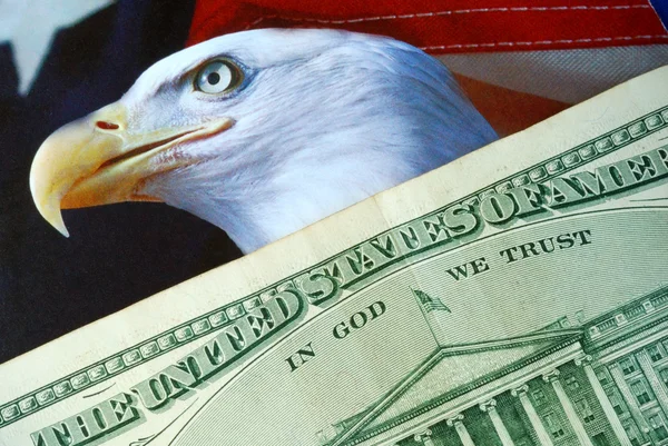 A dollar bill on the American Eagle flag