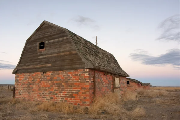 Abandoned farm buildings in prairie