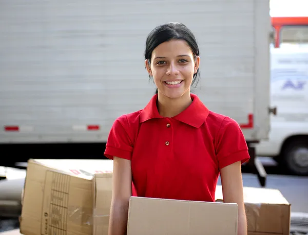 Delivery courier or mover delivering cardboards