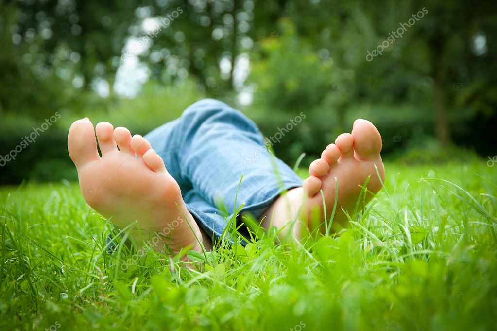 Feet of a sexy young woman lying in the grass
