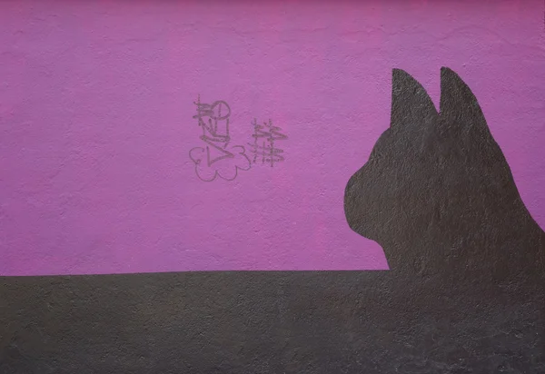 Wall with painted silhouette of a cat