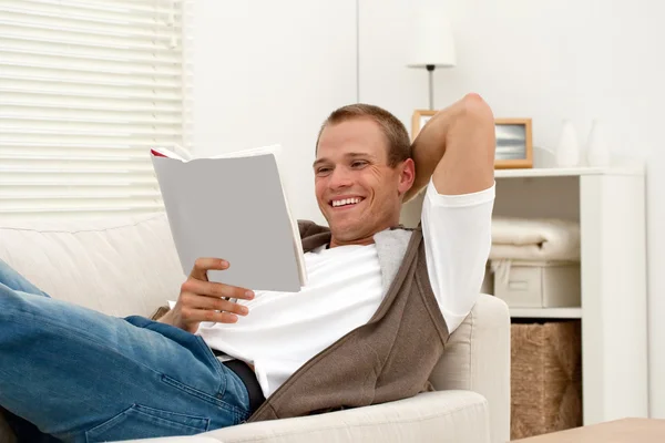 Smiling man reading book