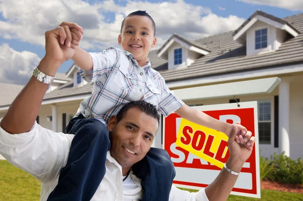 Hispanic Father and Son with Sold Sign
