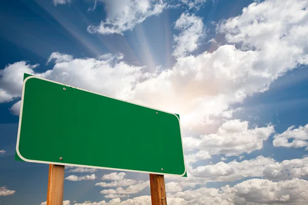 Blank Green Road Sign over Dramatic Sky