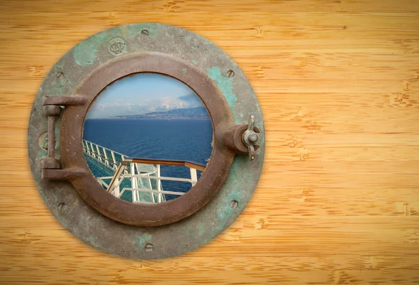 Antique Porthole on Bamboo Wall with View of Ship Deck Railing a