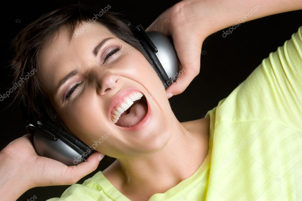Singing woman wearing headphones