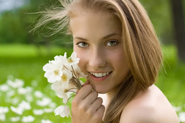 Pretty teen girl with white bouquet near the face by Irina Pussep Stock