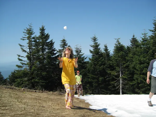Barefoot woman playing snowballs