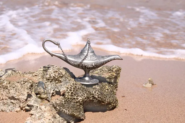Magic silver lamp on a sea background