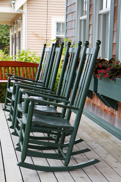 Four green rocking chairs
