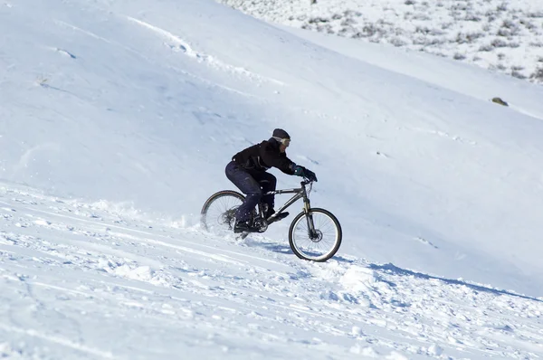 Snow downhill on bike