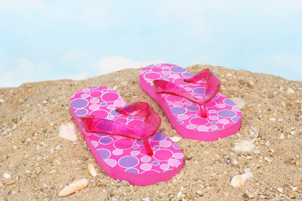 Pink Flip Flops on Sandy Beach