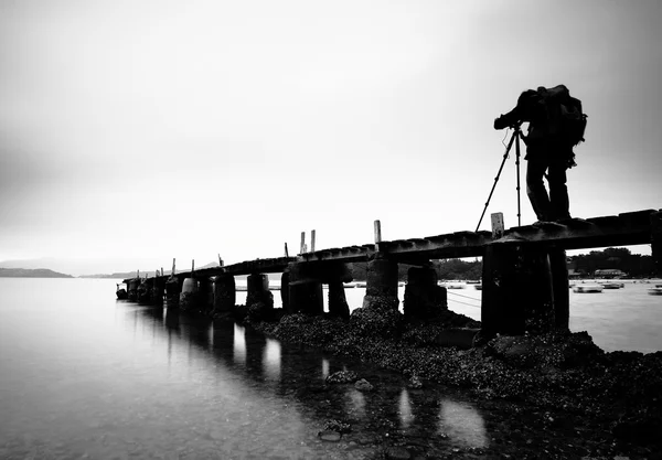 Wooden pier with a man , black and white
