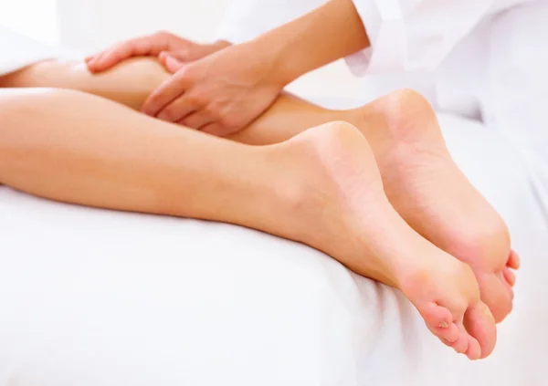 Closeup of beautiful legs receiving massage on white by Yuri Arcurs Stock 