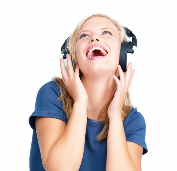 Young woman listening to music using headphones isolated by Yuri Arcurs 