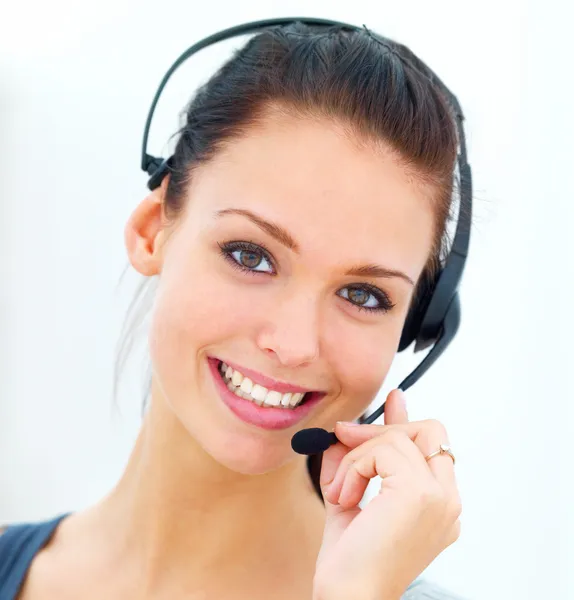 Closeup of a happy young woman wearing headphones by Yuri Arcurs Stock 