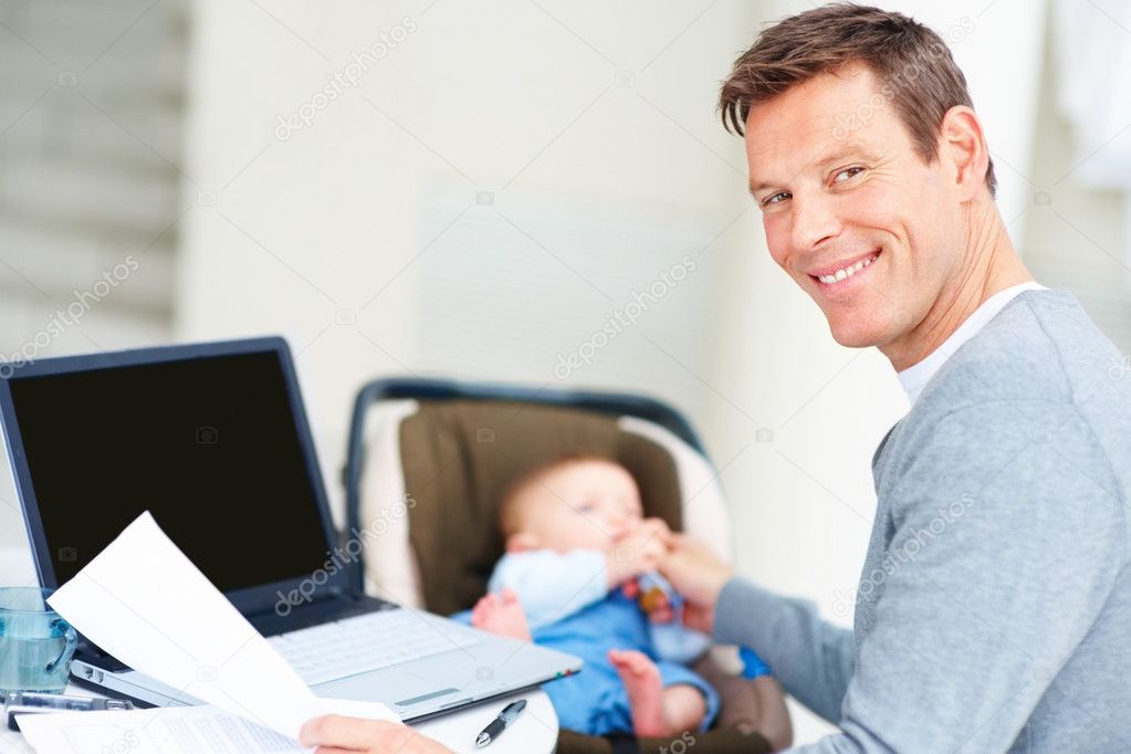 http://static4.depositphotos.com/1011061/329/i/950/depositphotos_3298229-Young-business-man-working-on-a-laptop-with-her-baby-at-the-back.jpg