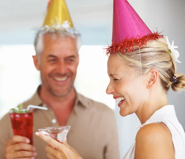 Happy mature couple enjoying a birthday party by Yuri Arcurs Stock Photo