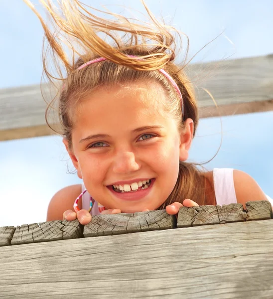 Closeup of a sweet teen girl lying on a bridge on a windy day by Yuri