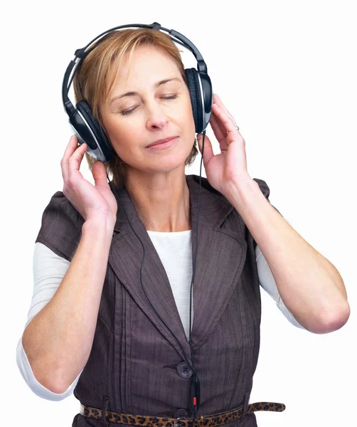 Pretty mature lady enjoying music on headphones by Yuri Arcurs Stock Photo