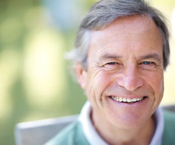 Portrait of cheerful mature man smiling Outdoor by Yuri Arcurs Stock 