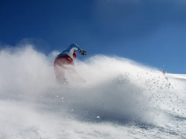 Girl snowboarding in powder snow