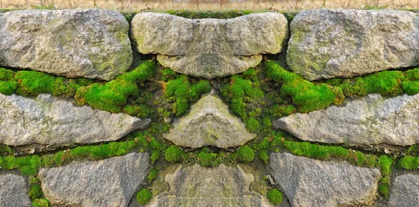 Stone wall, becoming over green moss