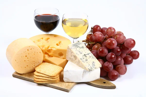 Various types of cheese, wine and grapes