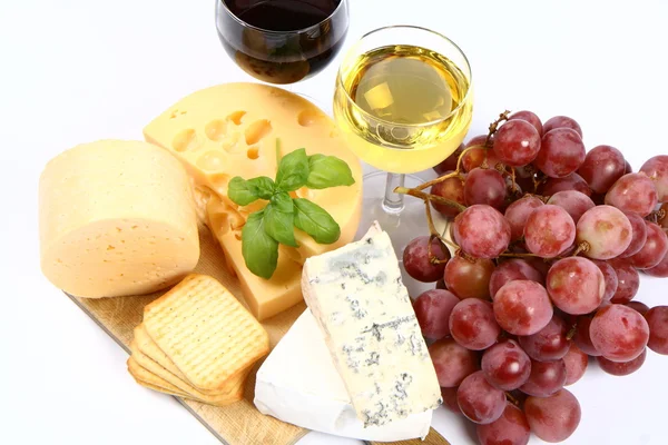 Various types of cheese, grapes, wine
