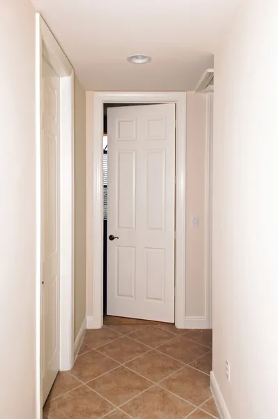 Tiled hallway with doors