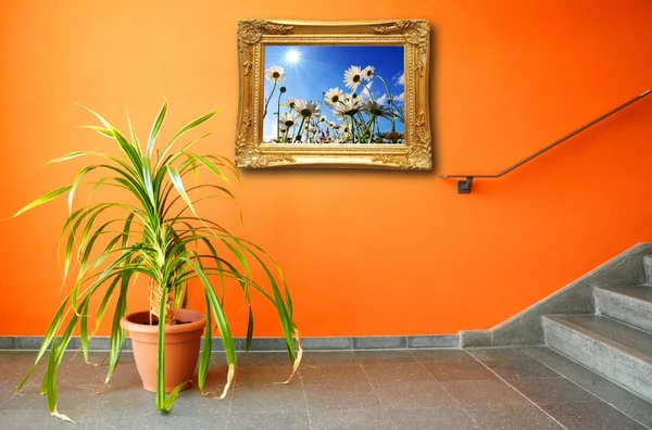 Picture on a wall and plant