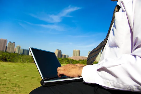 Business man working on a laptop outdoor