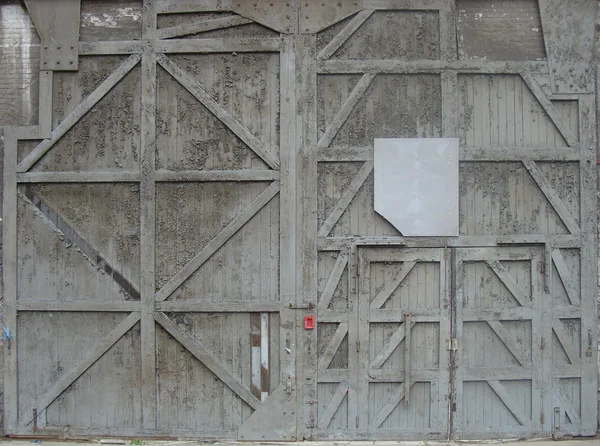 Large worn dirty industrial factory door gate