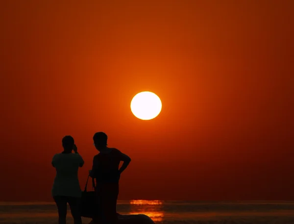 Photographers taking a photograph of sunrise