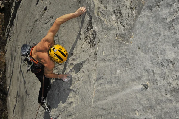 Climber climbs on rock