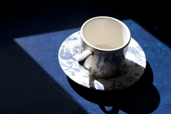 A Chinese tea cup silhouetted