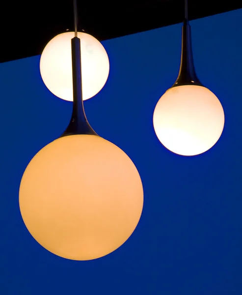 Three balls lamps hanging on a patio