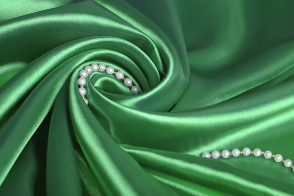 Pearl beads on green silk