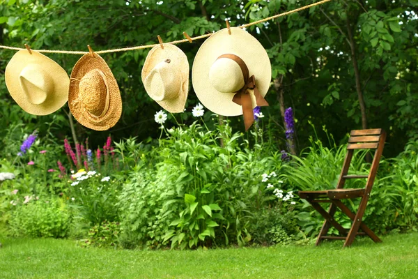Summer straw hats hanging on clothesline