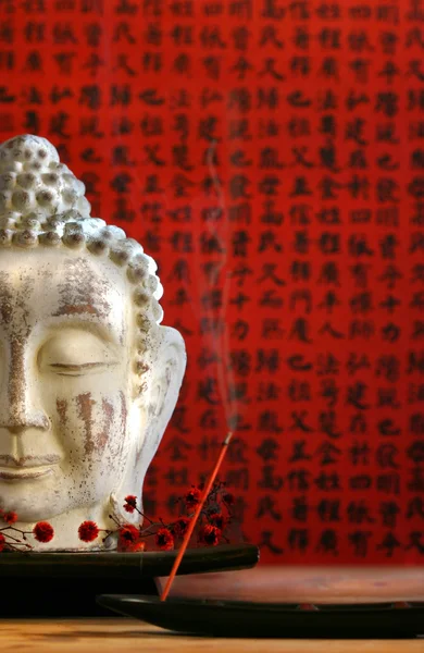 Buddha head and incense