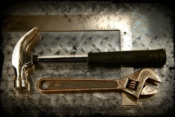 Work tools on a grunge metal background