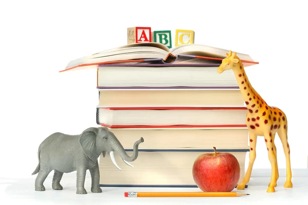 Stack of books with toy animals