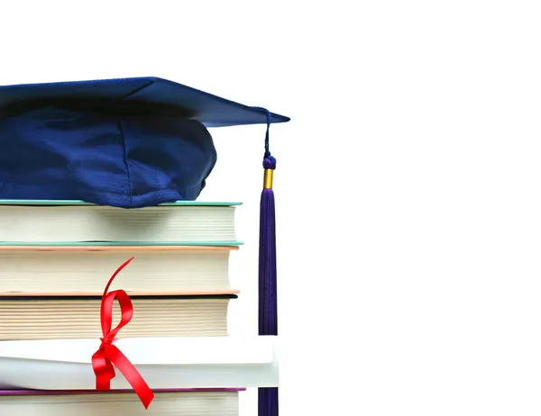 Stack of books with cap and diploma on white