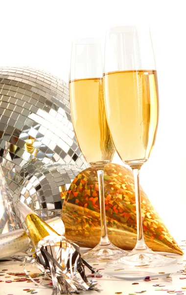Champagne glass with gold party hats and disco ball