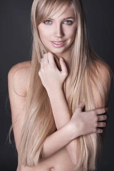 Portrait of beautiful young woman with long straight blond hair