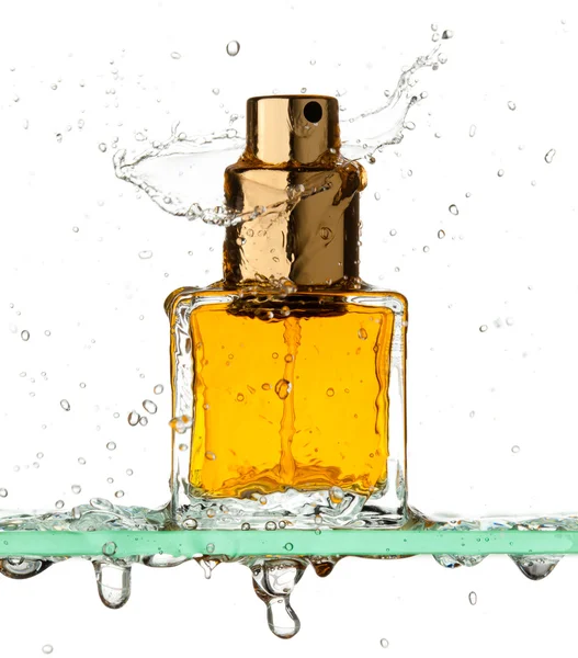 Bottle of perfume in a spray of water