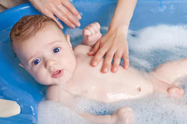 Relaxed baby in bath
